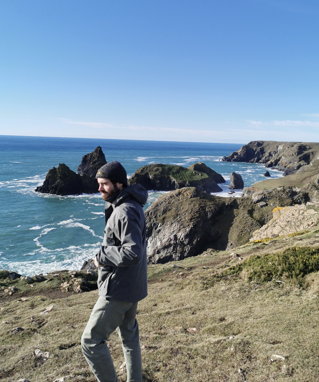 Josh Payne on a coastal clifftop, looking out across the sea